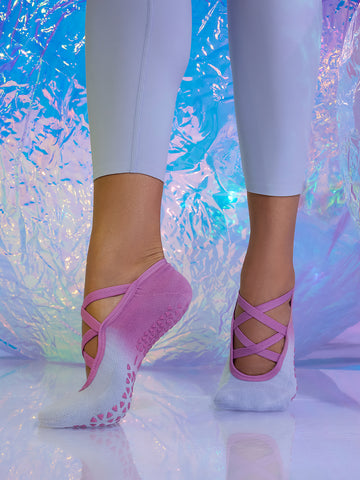 Close-up of pink Tavi crisscross ballet grip socks showing the textured non-slip sole